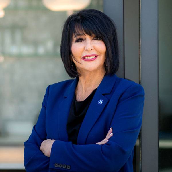 President Mantella standing by a glass wall